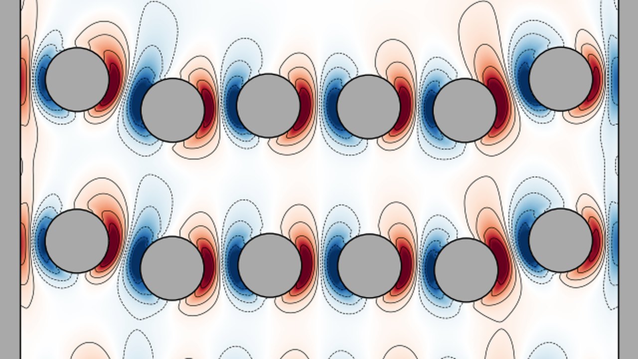 Disks settling in a box, coloured by vorticity, with their wakes
